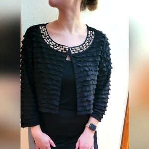 Black ruffled bolero top from Chico's Traveler's collection. Size 2.